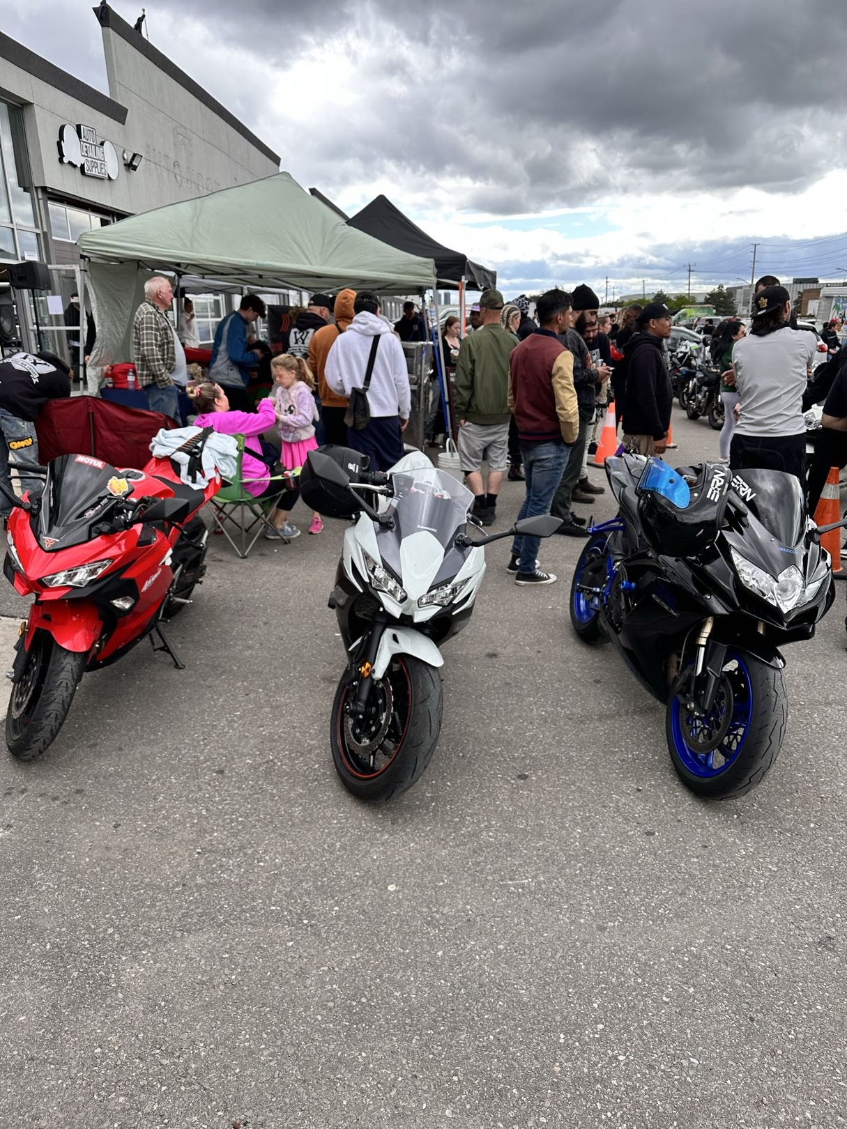 Community event with crowd, tent, and bikes